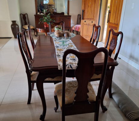Vintage-style mahogany table with ball and claw legs and eight upholstered chairs. With French High-leg XV Antique sideboard and Chest of drawers