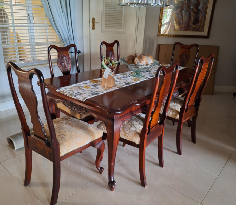 Vintage-style mahogany table with ball and claw legs and eight upholstered chairs. With French High-leg XV Antique sideboard and Chest of drawers